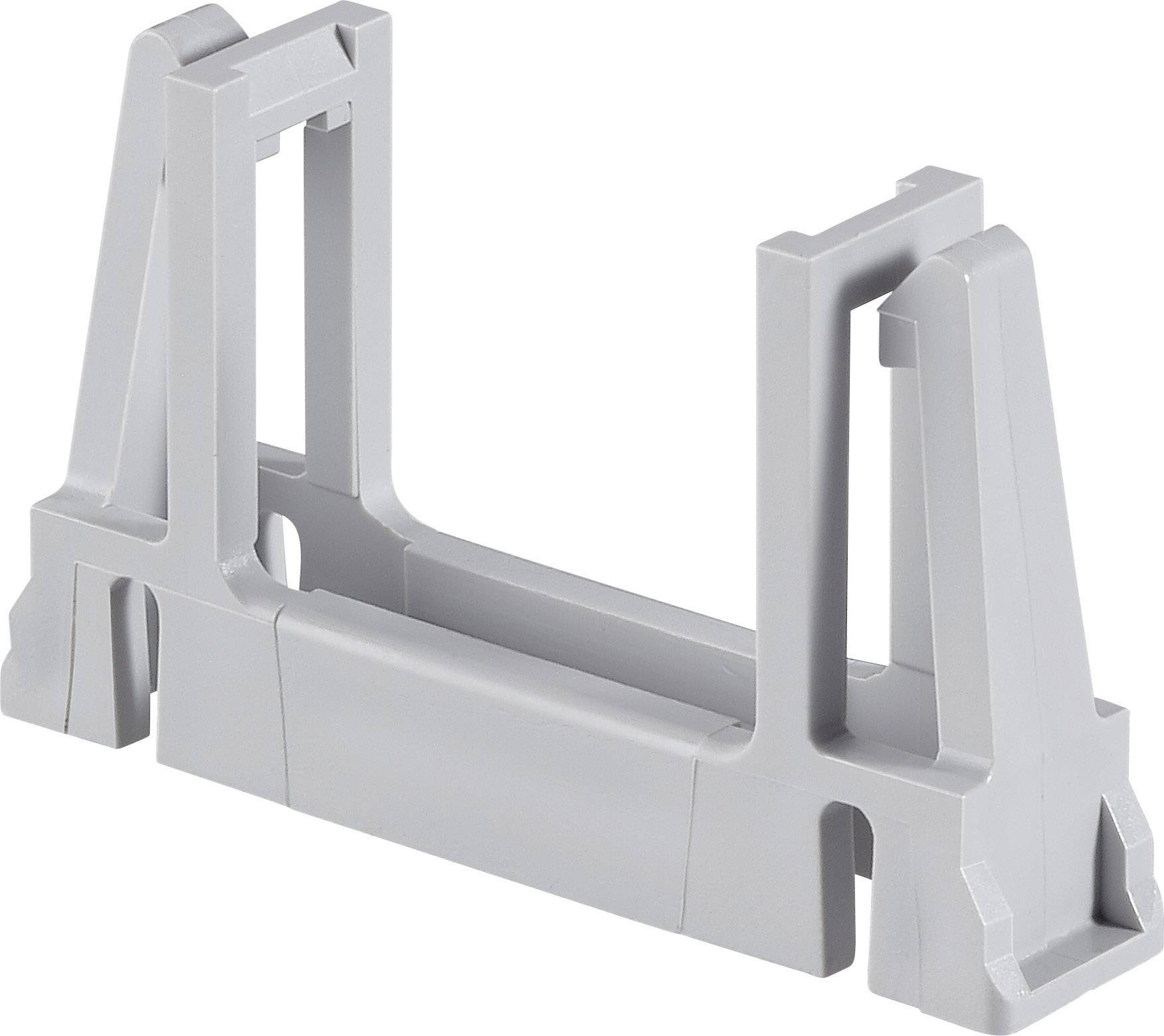 Pièce en plastique grise, probablement un composant ou un adaptateur, avec plusieurs connexions à angle droit et une base stable.
