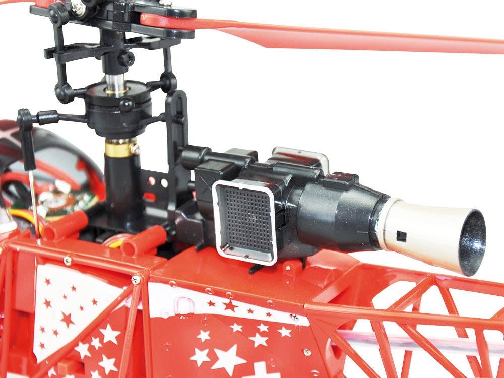 Gros plan d'un hélicoptère miniature rouge avec des motifs en étoile, montrant l'ensemble du rotor et une turbine stylisée.