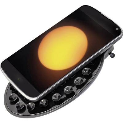Un smartphone repose sur un objet ressemblant à une râpe à fromage. Un cercle jaune-orange lumineux est visible sur l'écran.