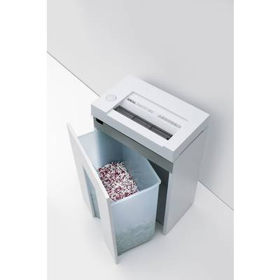 Un destructeur de documents déchiquette des bandes de papier dans un récipient. L'appareil se trouve dans un environnement de bureau moderne.