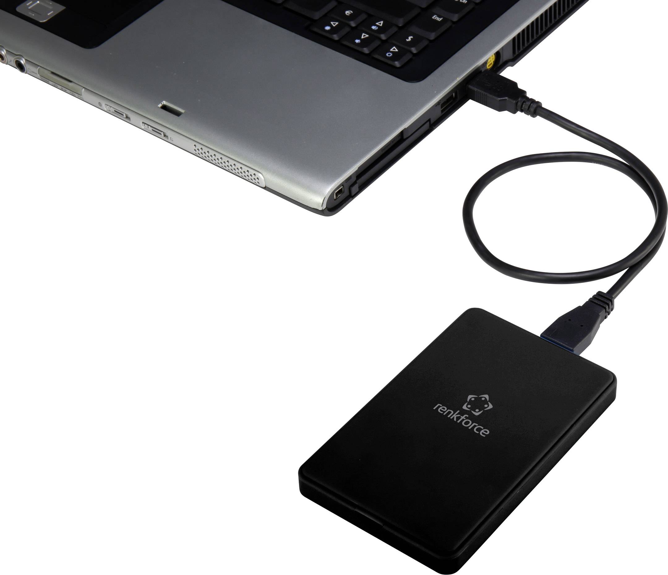 Un disque dur externe, connecté à un ordinateur portable via un câble USB. Idéal pour le stockage de données supplémentaires et les solutions de sauvegarde.