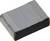 Un aimant en néodyme rectangulaire, plat, gris avec des coins arrondis repose sur une surface blanche.