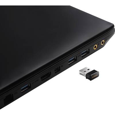Ordinateur portable avec plusieurs ports sur le côté, comprenant USB, HDMI et Audio. Un adaptateur USB est posé à côté.