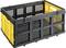 Une boîte en plastique noir et jaune avec des grilles ouvertes et une poignée, adaptée au stockage ou au transport.