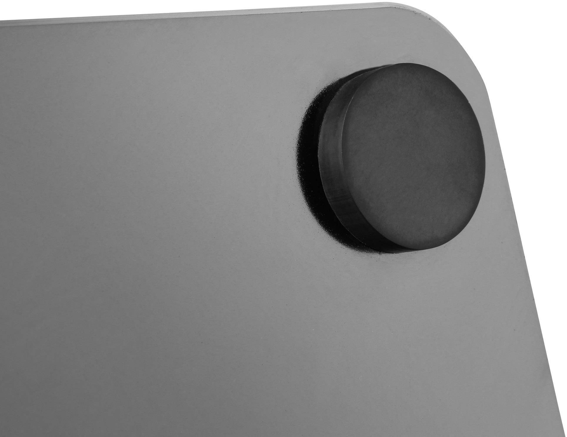 Un support de tableau magnétique rond et noir sur une surface magnétique grise.