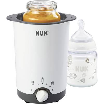 Sur l'image, on peut voir un chauffe-biberon avec un pot d'aliments pour bébé et un biberon de la marque 'NUK'.
