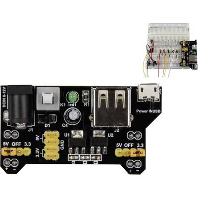 Une carte électronique noire avec plusieurs ports et interrupteurs pour l'alimentation électrique, connectée à une breadboard représentant des circuits.