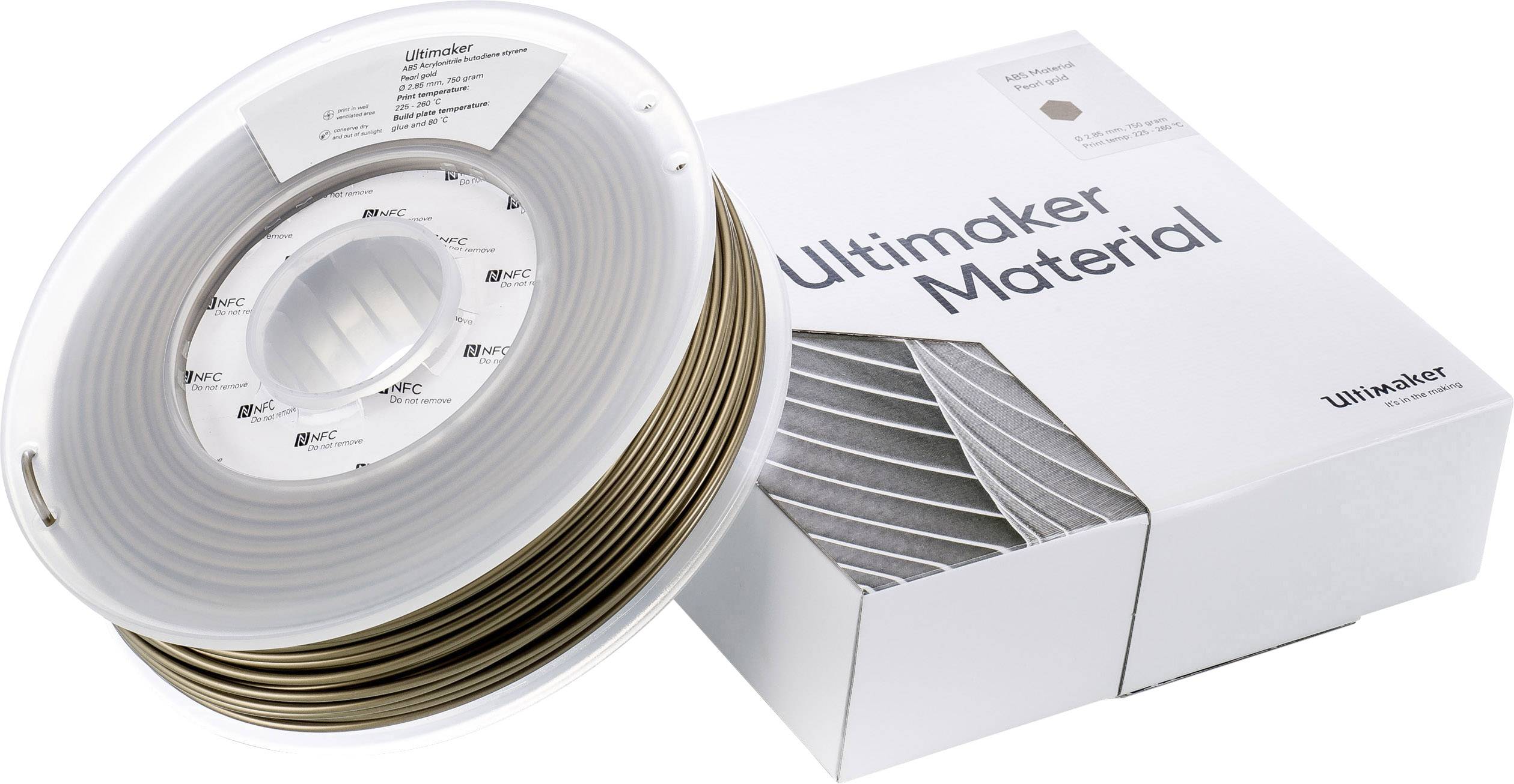 Un rouleau de filament d'impression 3D bronze devant un emballage portant l'inscription 'Ultimaker Material'.