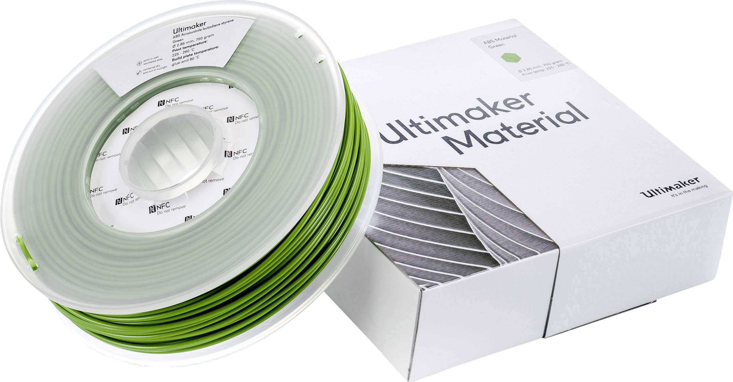 Bobine de filament vert et son emballage portant l'inscription 'Ultimaker Material', utilisés pour l'impression 3D.