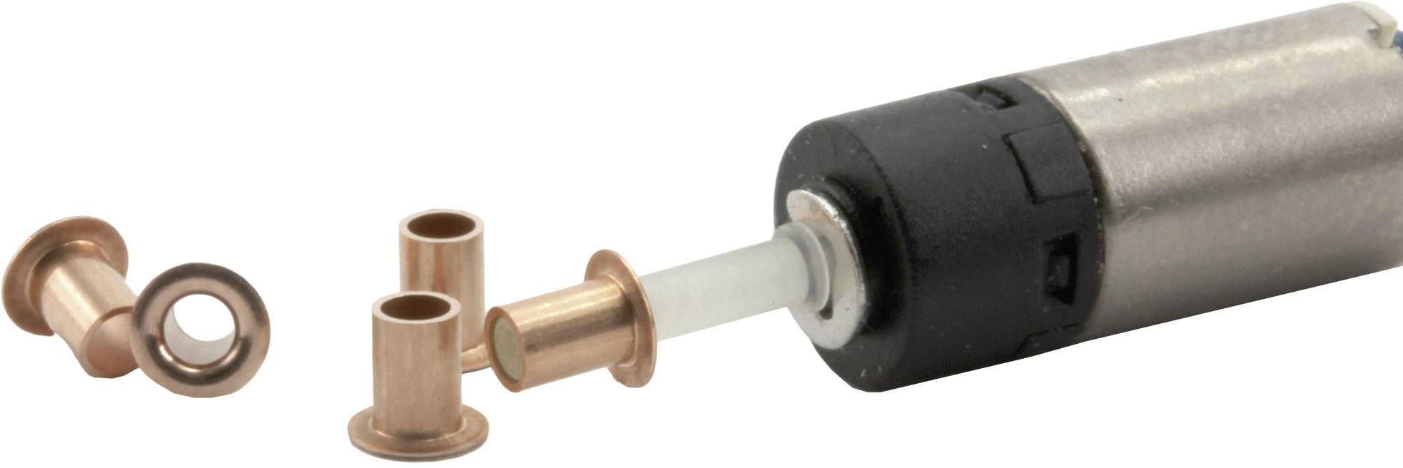 Des douilles couleur cuivre et une pointe en plastique ronde qui dépasse d'un appareil noir et argenté. Utilisation dans des applications mécaniques.