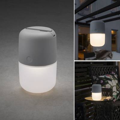 Lampe LED portable présentée sur une table, pour intérieur et extérieur, lumière chaude et variable, idéale pour un éclairage de soirée.