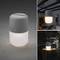 Lampe LED portable présentée sur une table, pour intérieur et extérieur, lumière chaude et variable, idéale pour un éclairage de soirée.