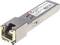 Un module SFP avec boîtier métallique et connecteur. Il porte des marquages et des logos de conformité tels que FCC et CE.