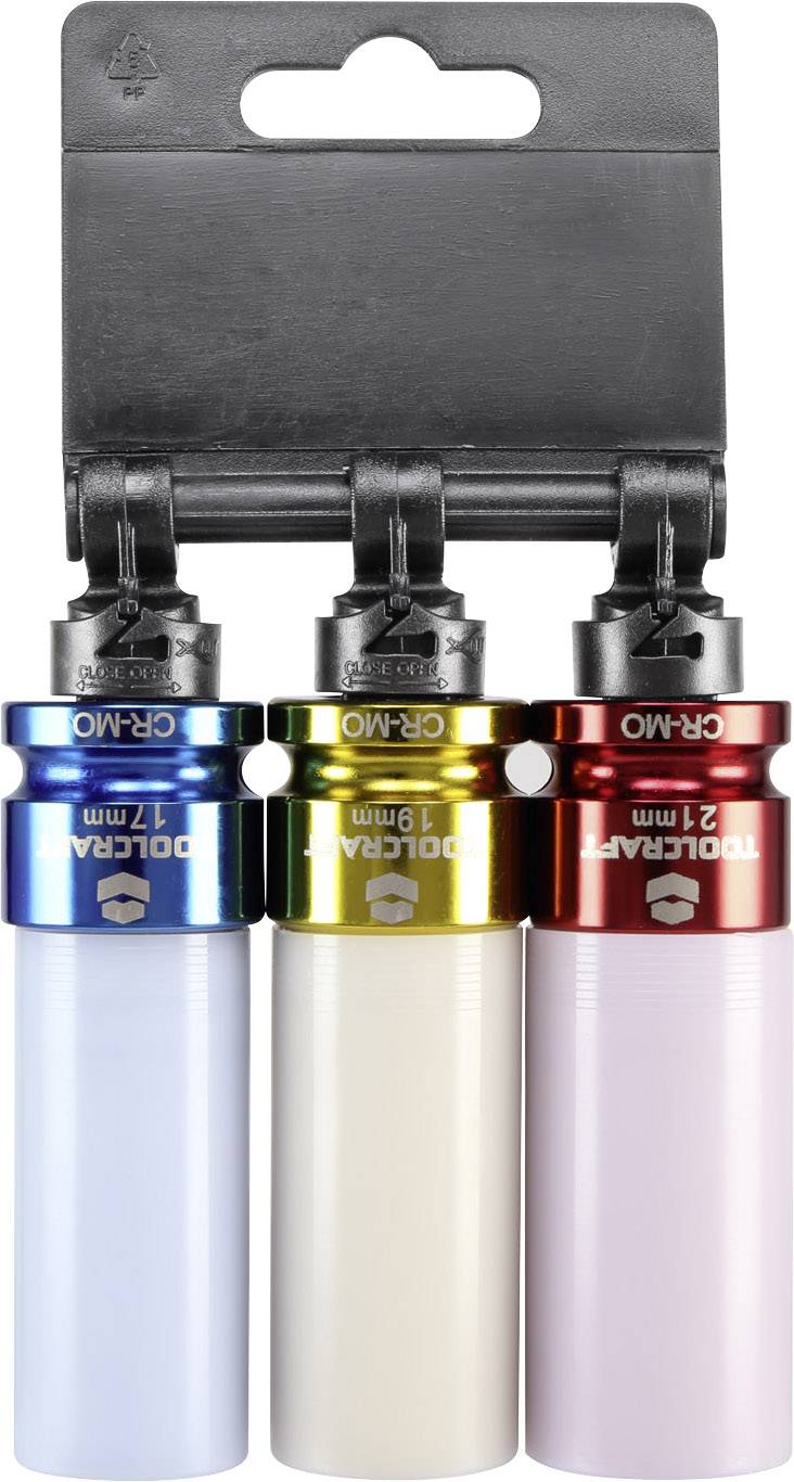 Trois adaptateurs de clés à différentes couleurs (bleu, jaune, rouge) fixés sur un support noir, chacun portant des marquages de taille.