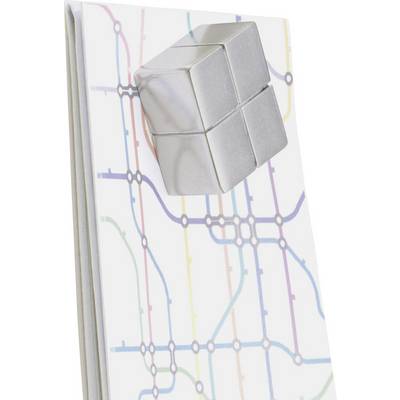 Un cube argenté sur un carnet au motif de réseau de lignes colorées, évoquant un plan de métro.