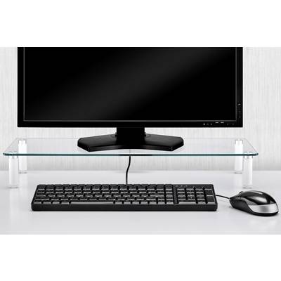 Un ordinateur avec écran posé sur un support en verre, avec un clavier et une souris en dessous sur une table blanche.