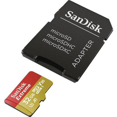 Carte microSD SanDisk de 32 Go à côté d'un adaptateur microSD. La carte est rouge et or avec l'inscription 'SanDisk Extreme'.