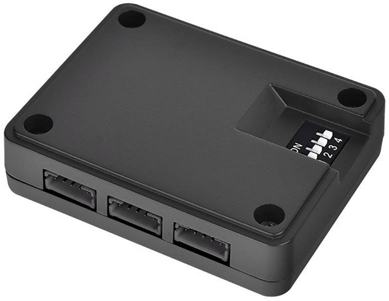 Un appareil électronique noir rectangulaire avec quatre petits interrupteurs sur le côté, probablement utilisés pour le contrôle ou la configuration.