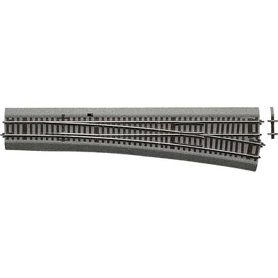 Un aiguillage de train miniature, montrant deux directions de voie : vers la gauche et tout droit. Parfait pour représenter des itinéraires ferroviaires.