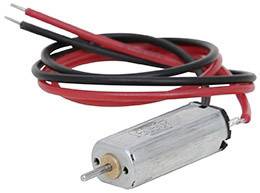 Un petit moteur électrique cylindrique avec des fils rouges et noirs attachés.