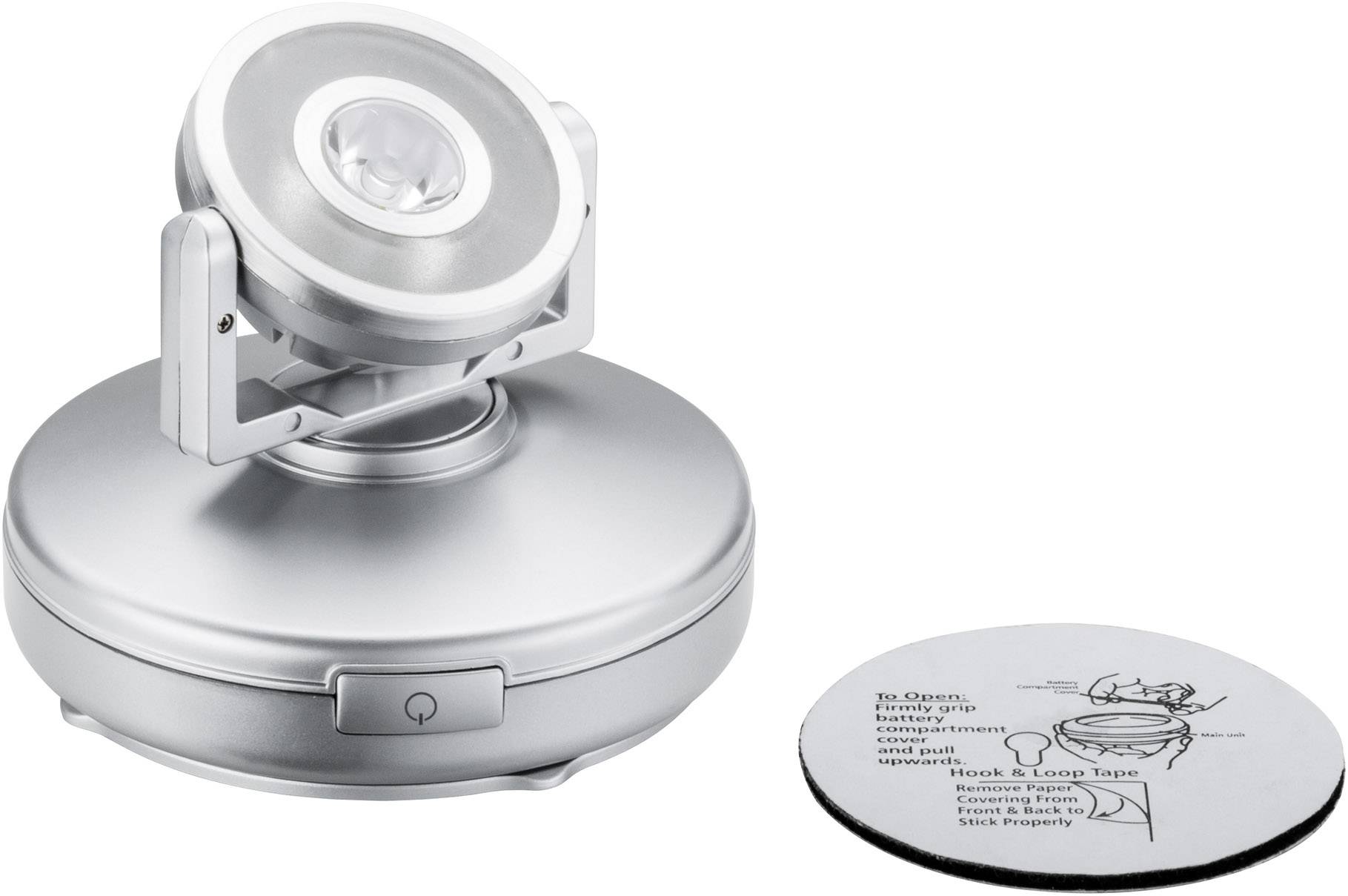 Lampe LED argentée avec tête rotative sur socle rond. À côté de la lampe se trouve un disque de mode d'emploi circulaire.