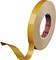 Un rouleau brun de ruban adhésif double face avec une bande autocollante partiellement décollée.