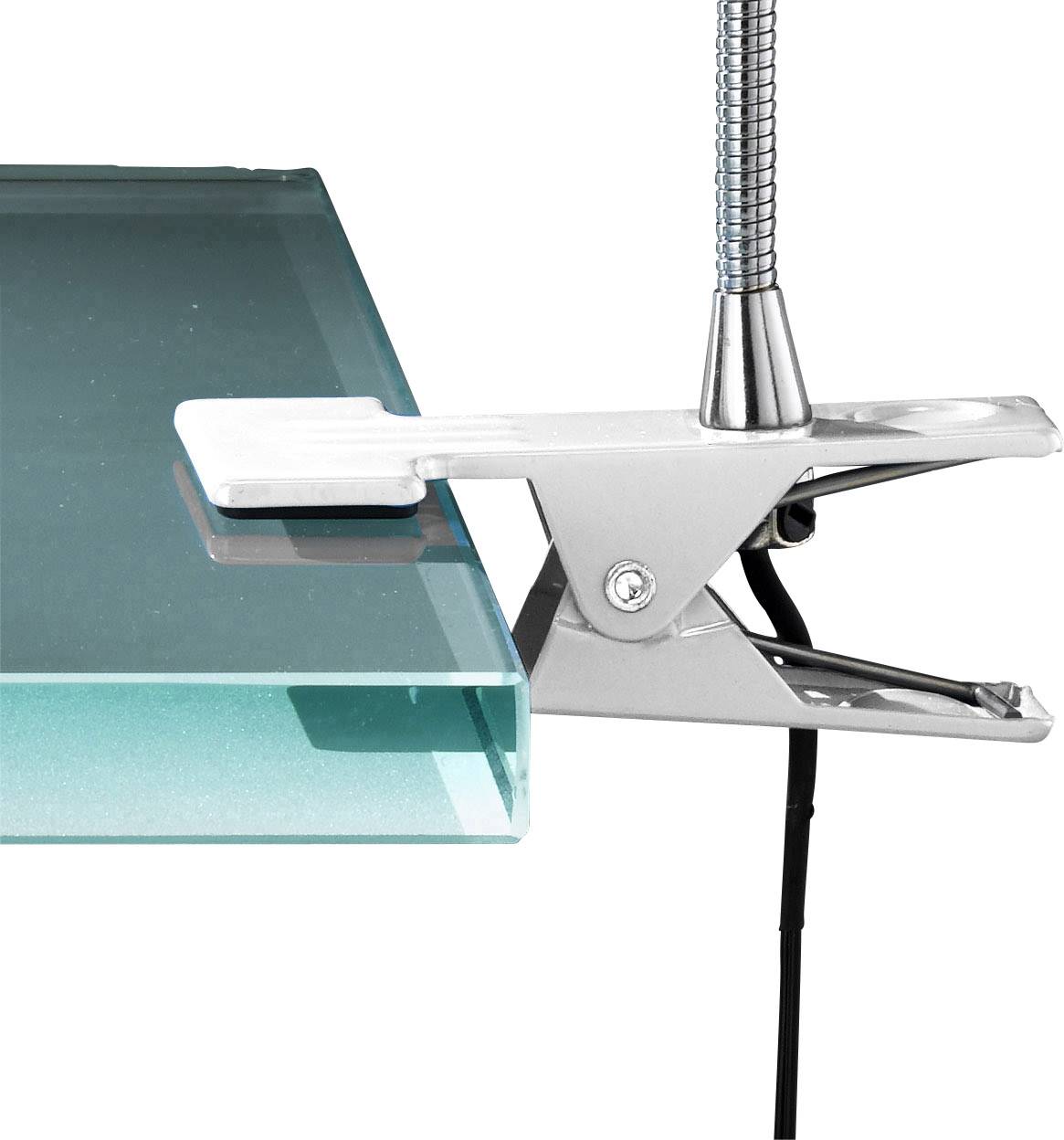 Un attache métallique maintient une plaque de verre. L'attache possède un mécanisme à ressort. Le verre présente une teinte verte.