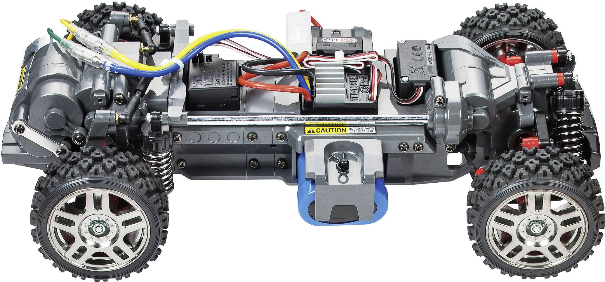 Châssis de voiture télécommandé avec électronique et câblage apparents, design ouvert, pneus à gros profil et cadre métallique.