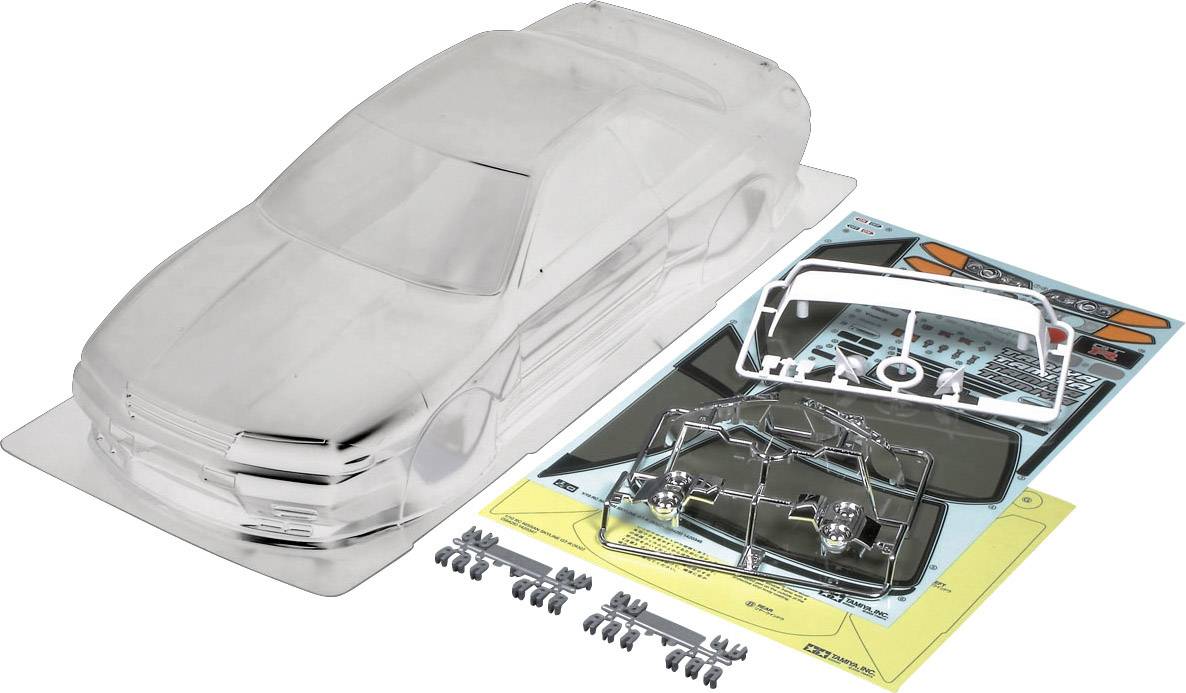 Kit de modélisme d'une voiture avec carrosserie transparente, autocollants et pièces détachées.