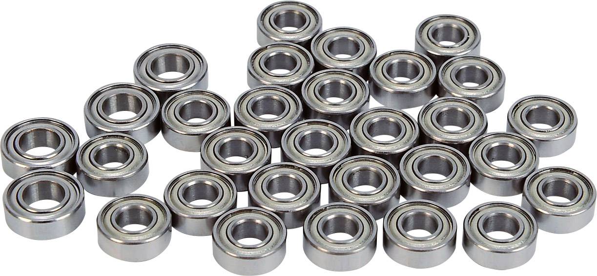 Plusieurs roulements à billes métalliques sont disposés sur une surface plane. Ils sont cylindriques et de couleur argentée.