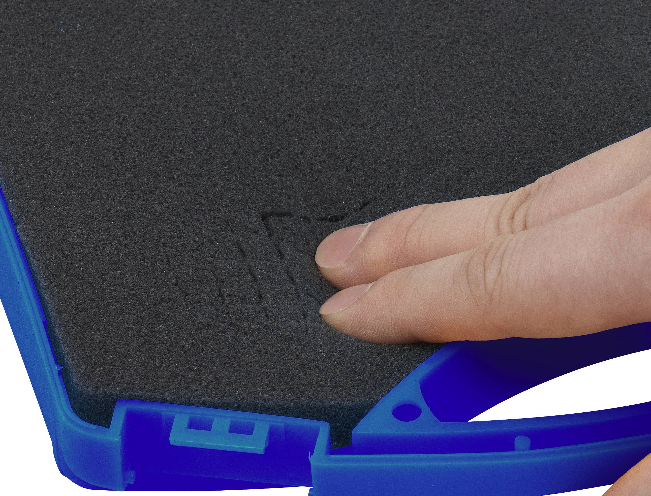 Une main appuie sur une mousse noire dans un cadre bleu pour démontrer l'élasticité et la résilience du matériau.