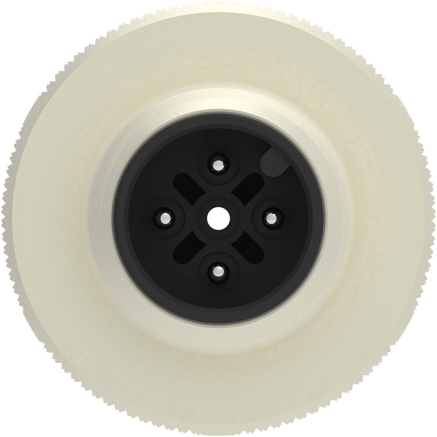Un bouton en plastique noir et rond avec quatre trous, entouré d'une couche nervurée couleur crème, ressemblant à une roue dentée.