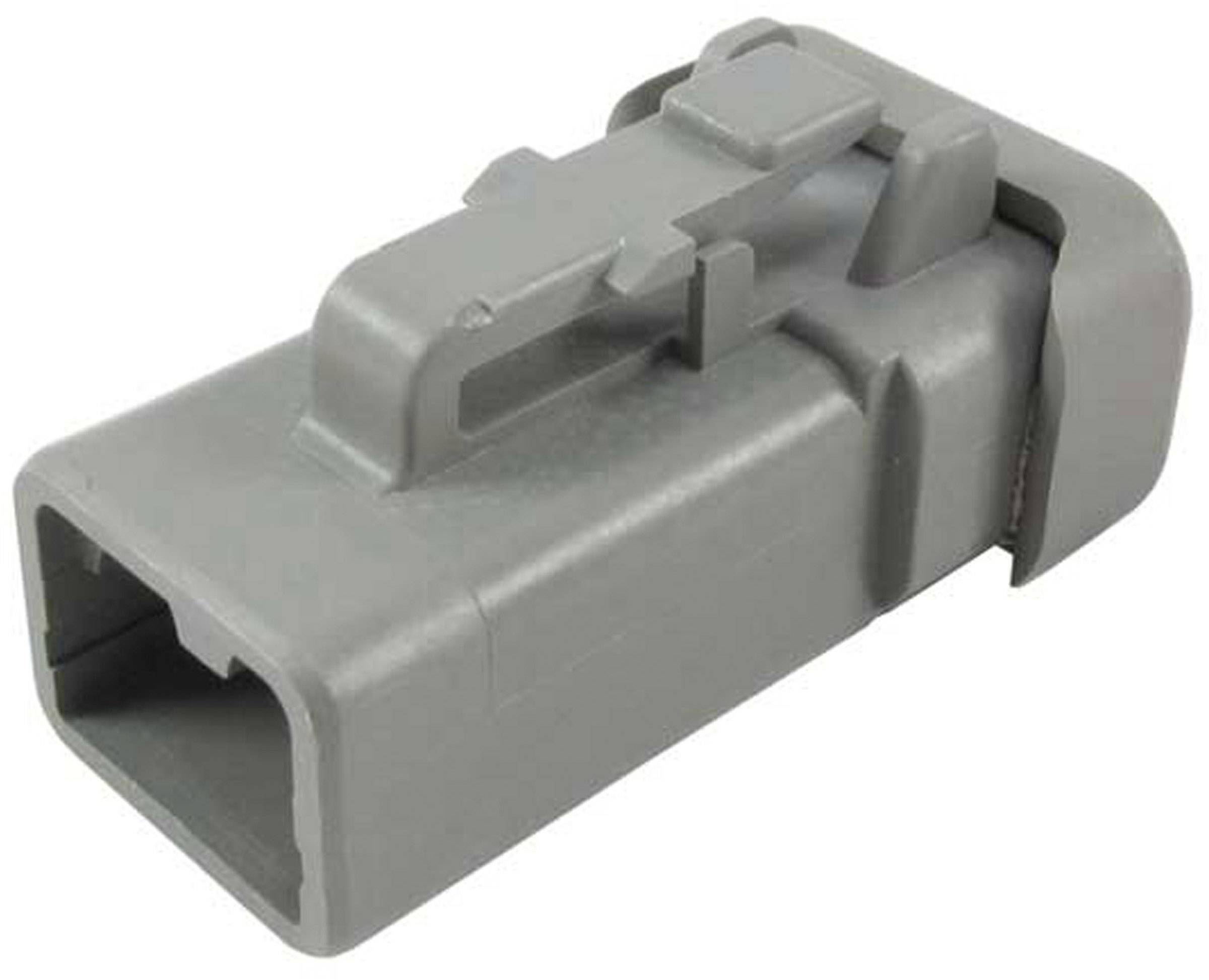 Un connecteur en plastique gris de forme rectangulaire avec un mécanisme de verrouillage, utilisé dans les connexions électriques pour véhicules.