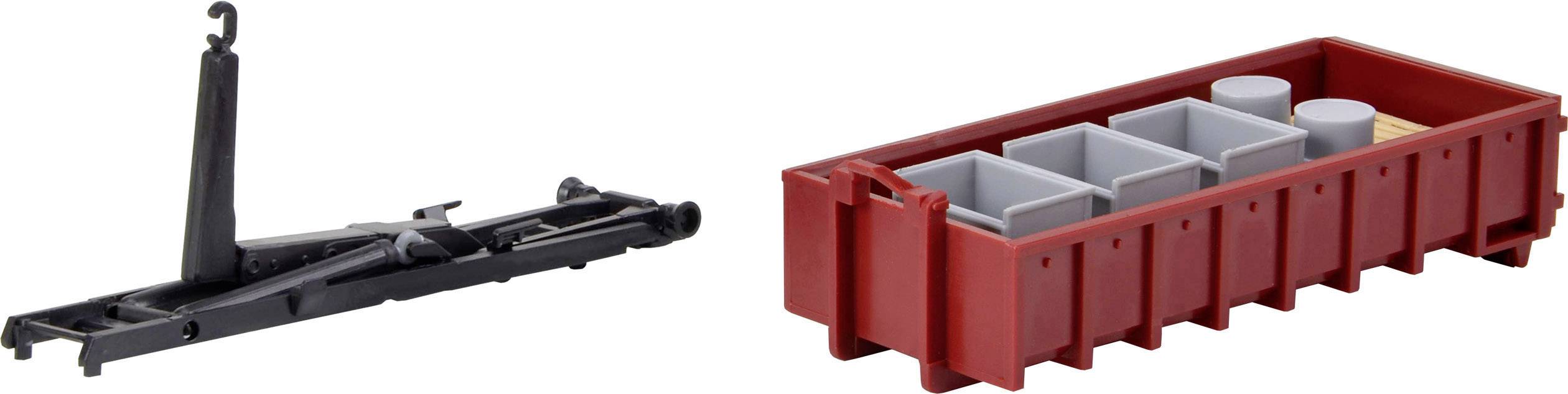 Un cric noir et une boîte à outils rouge à quatre compartiments contenant divers outils et petites pièces.