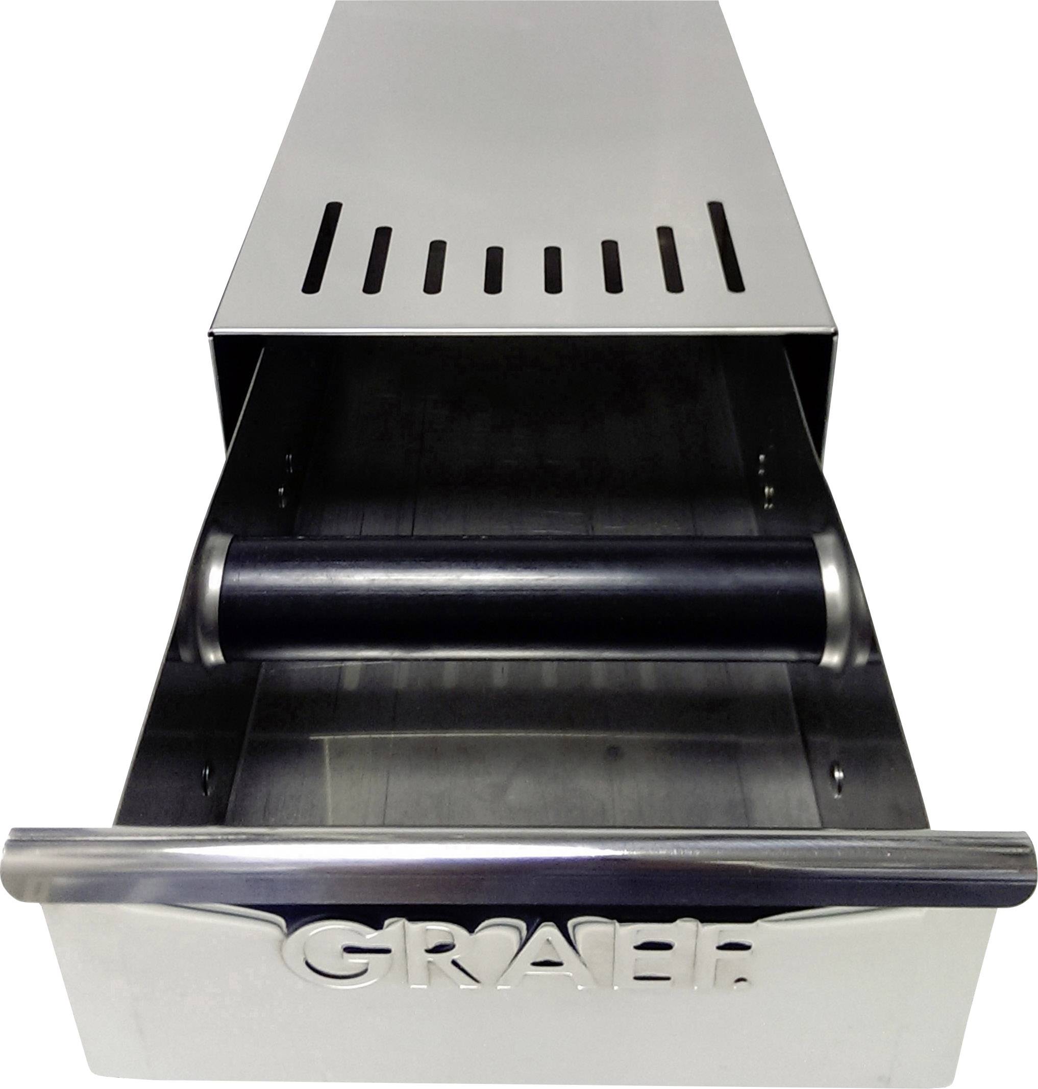 Un grand récipient rectangulaire en métal argenté avec des fentes sur le dessus et un cylindre noir au centre.