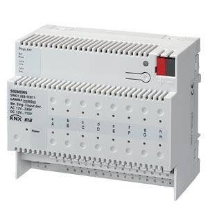 Un module de commutation KNX Siemens blanc avec des connexions en bas et deux boutons en haut, utilisé dans des systèmes de commande électrotechniques.