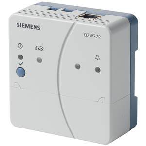 Une passerelle Siemens KNX blanche avec un bouton bleu et plusieurs symboles de connexion et d'alarme.