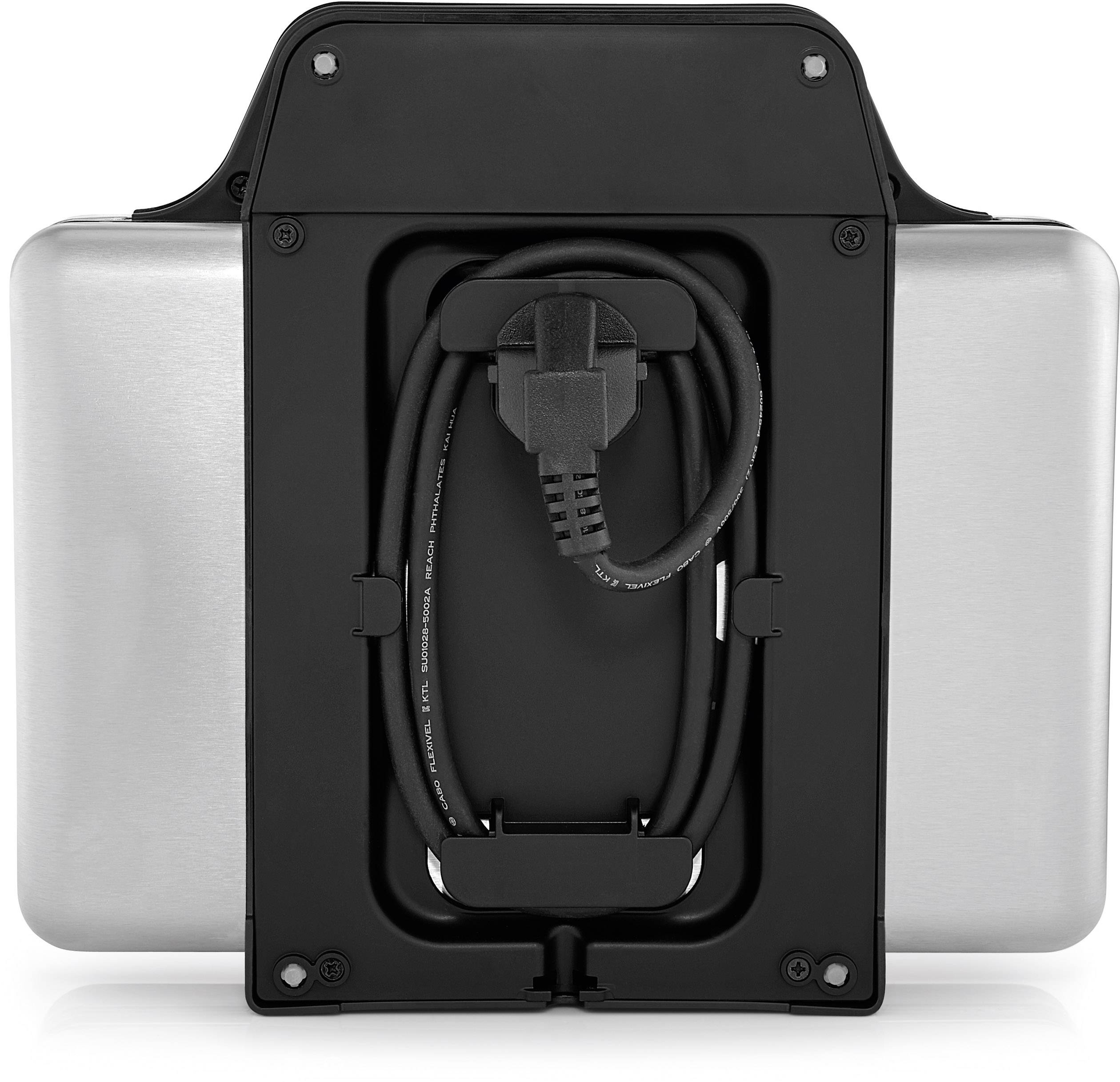 L'image montre l'arrière d'un appareil électronique argenté avec un câble d'alimentation connecté, soigneusement enroulé et inséré.