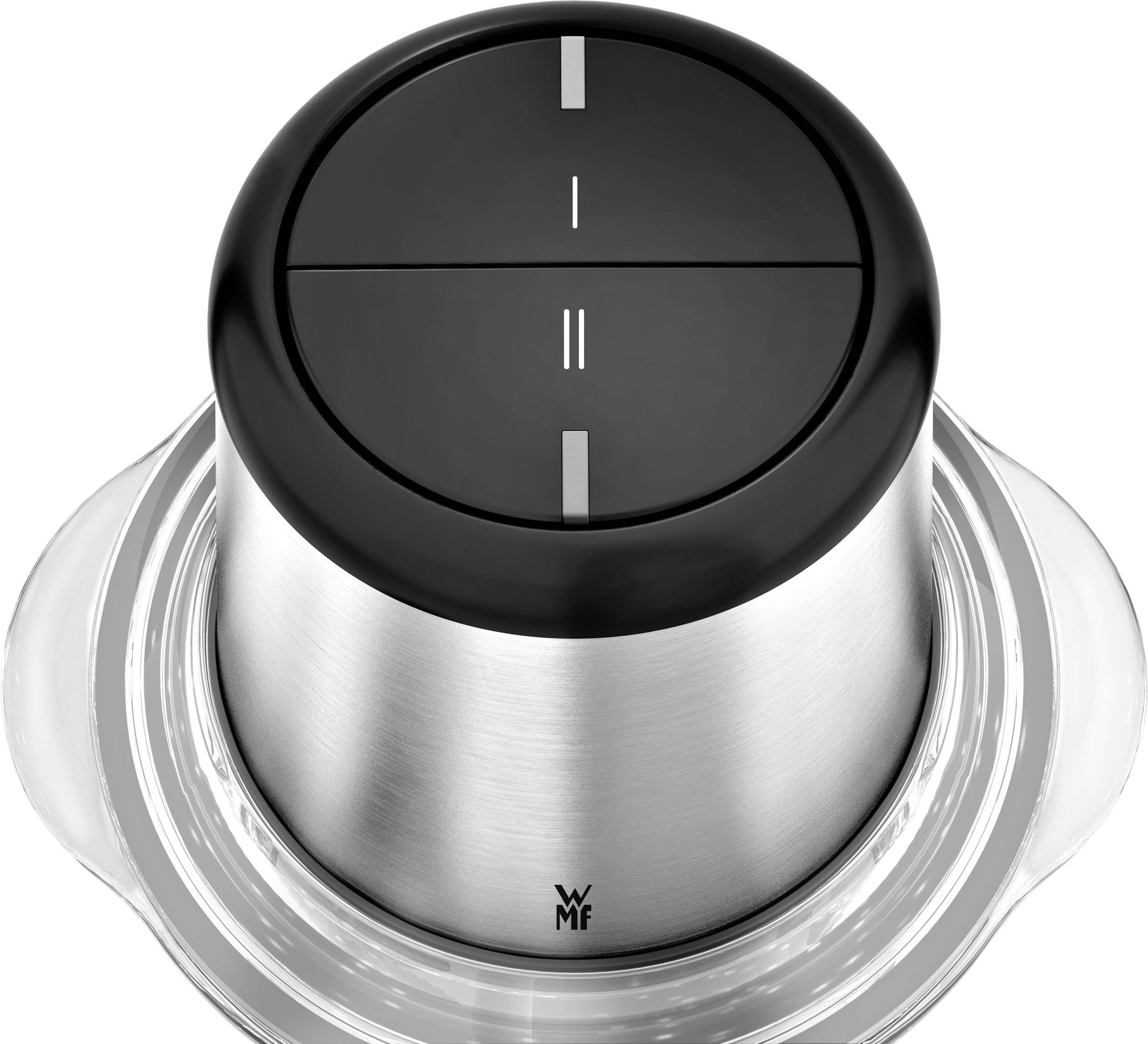 Un bouton rotatif rond en argent avec deux touches noires et un motif de traits, monté sur une base transparente.