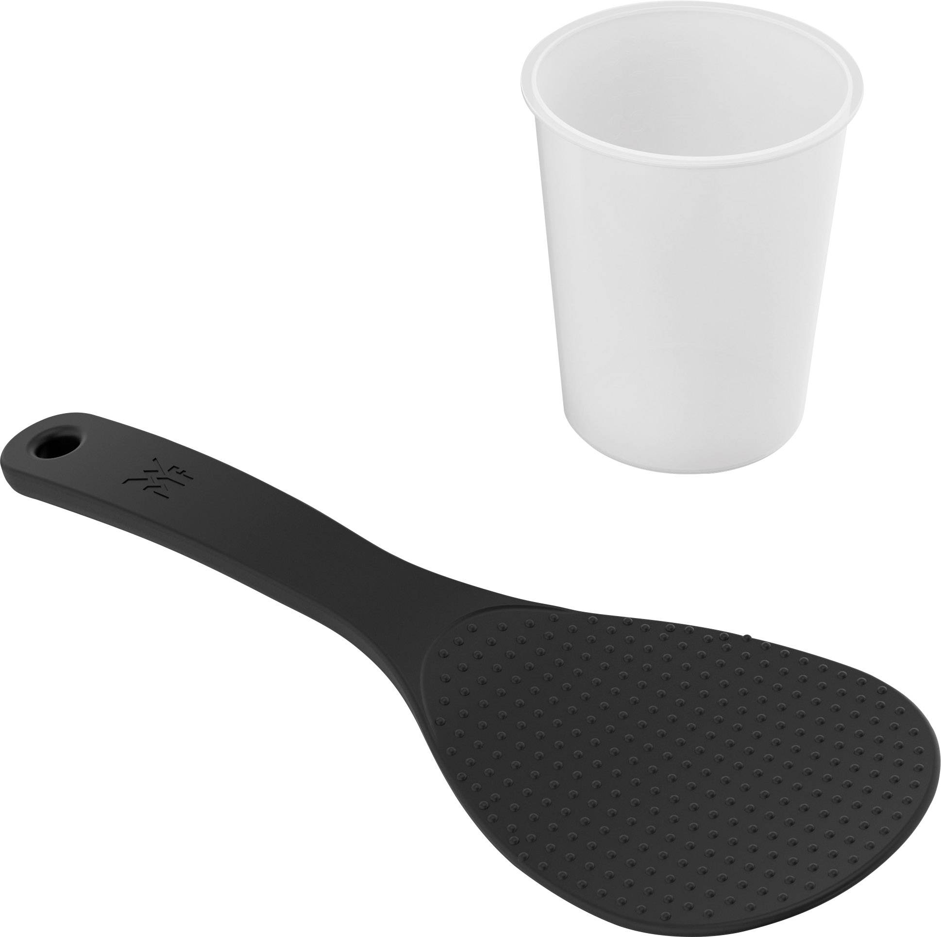 Une cuillère à riz noire est posée à côté d'un gobelet en plastique blanc. La cuillère a une surface à la texture rugueuse.