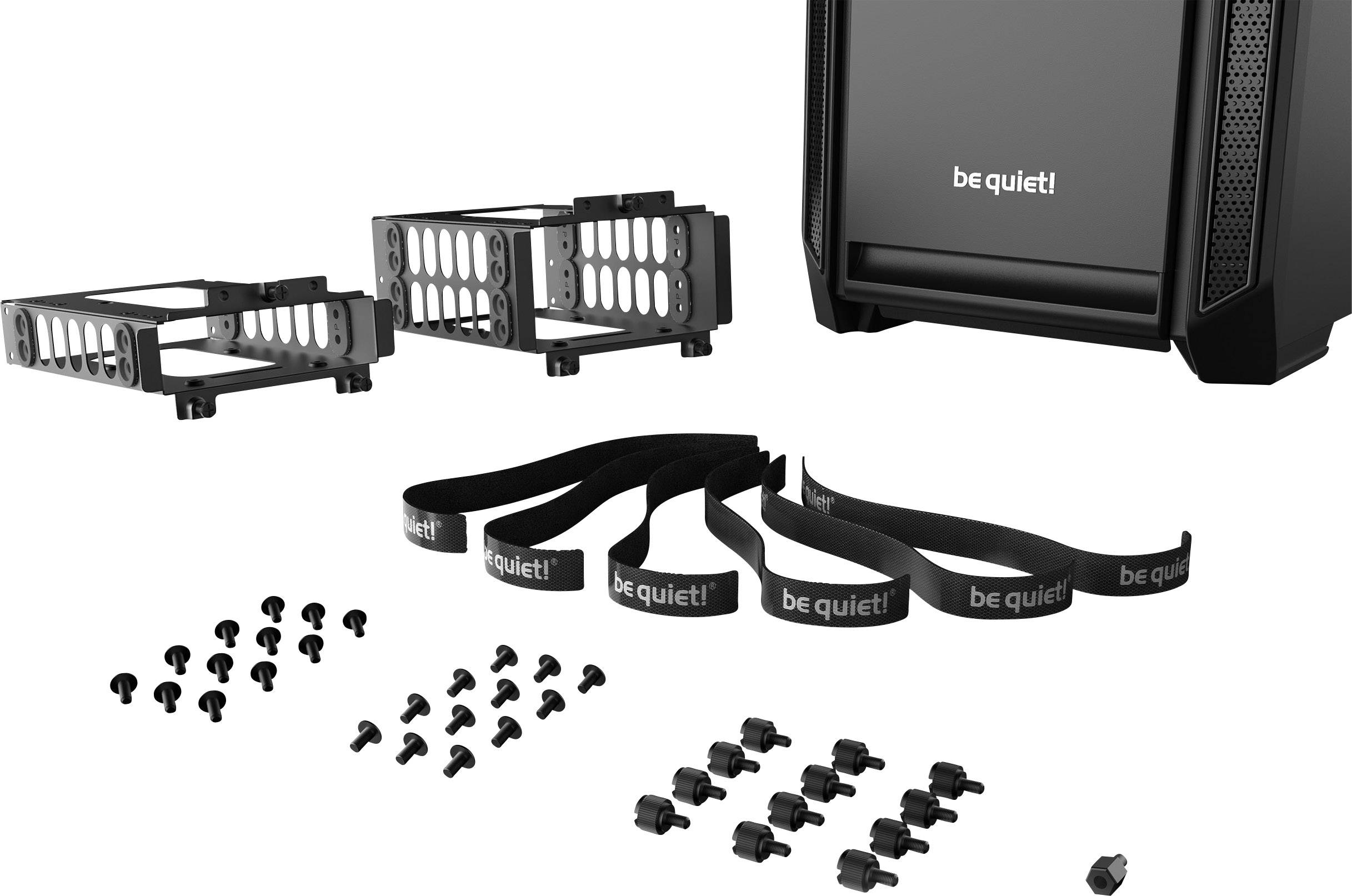 Ensemble d'accessoires devant un boîtier d'ordinateur, composé de deux supports de disque dur, de plusieurs vis et de serre-câbles portant le logo 'be quiet!'.