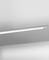 Un luminaire de plafond simple et moderne est installé sur un plafond blanc, apportant au lieu une esthétique claire et minimaliste.