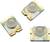 Trois petits puces LED avec des dômes sur une plateforme blanche, chacune dotée de contacts dorés aux coins.