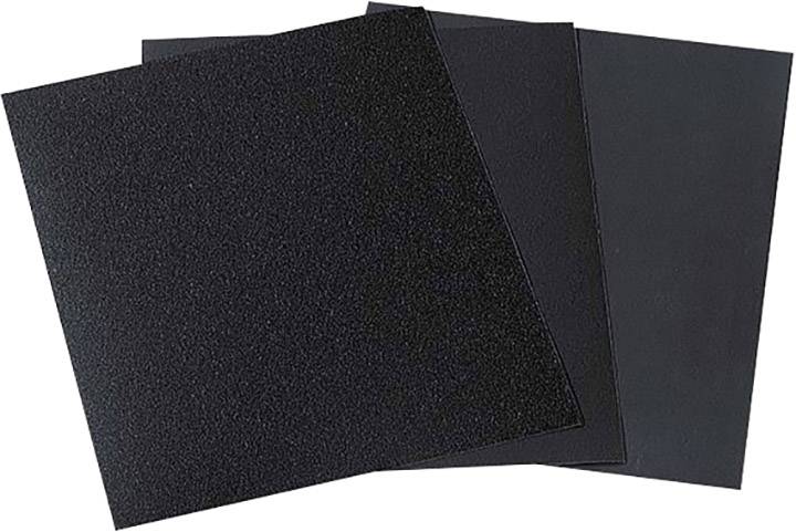 Trois feuilles de papier de verre noires de différentes granulométries sont superposées.