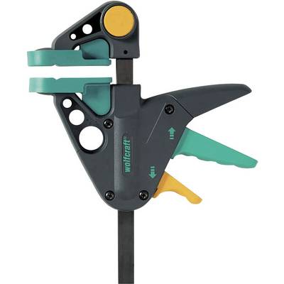 Un serre-joint à mécanisme de levier. Composants gris et verts, avec des touches de jaune. Utilisé pour maintenir des pièces de travail en place.