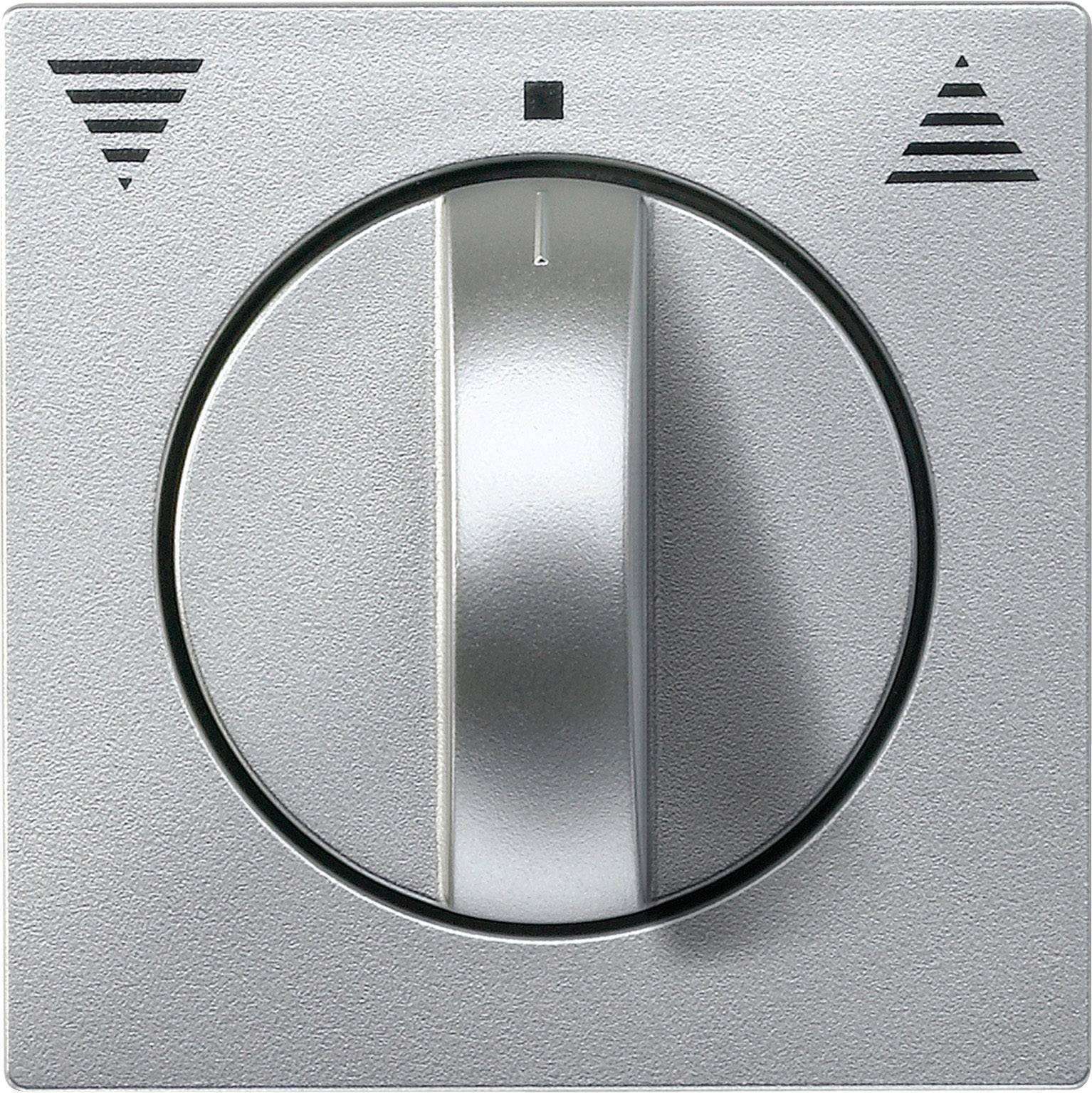 Un interrupteur rotatif argenté avec un marqueur fléché pointant sur l'un des trois niveaux marqués.