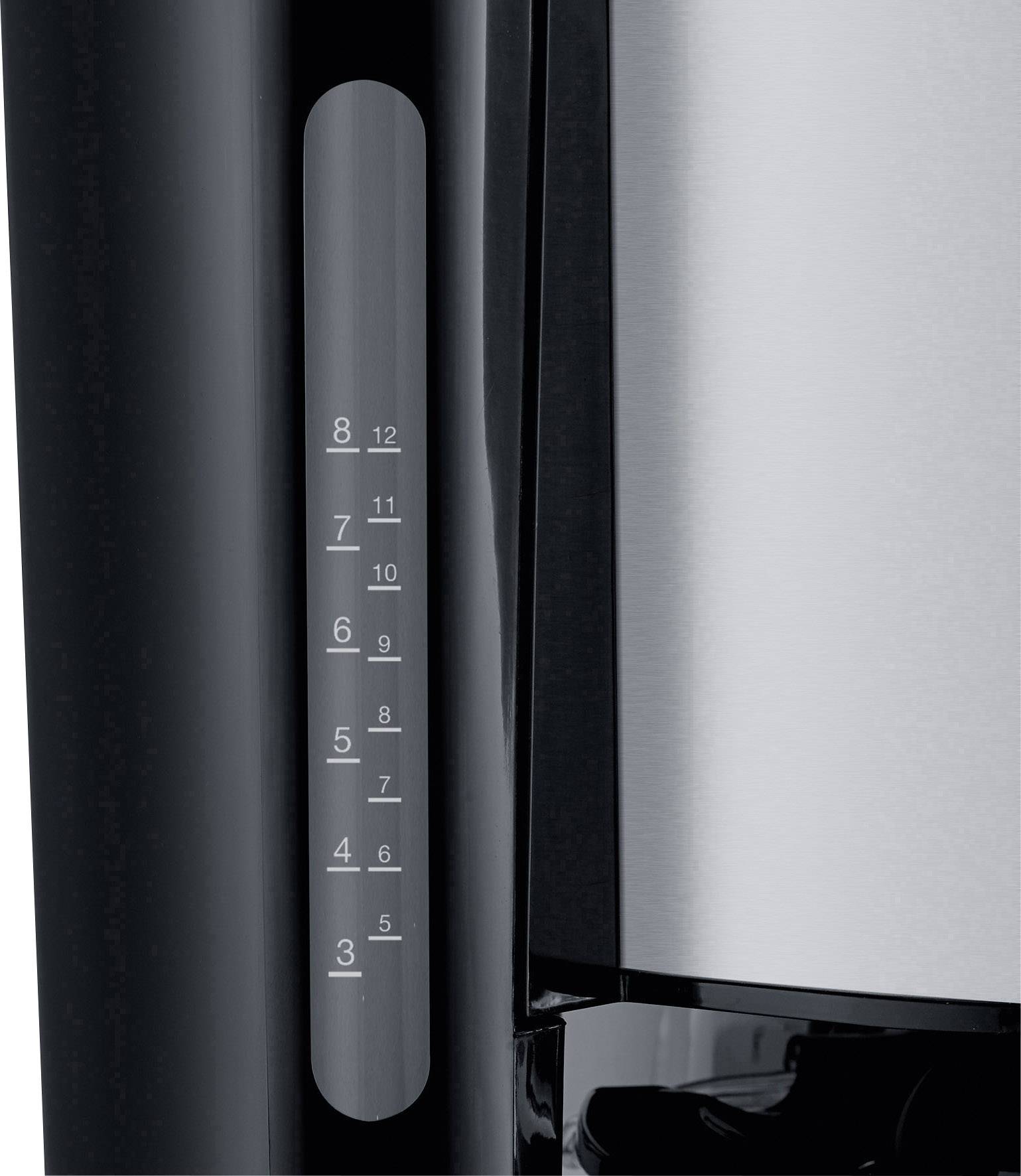 Une machine à café noir et argent avec indicateur de niveau d'eau. Capacité de 3 à 12 tasses. À gauche l'indicateur de niveau d'eau, à droite le récipient en acier inoxydable.