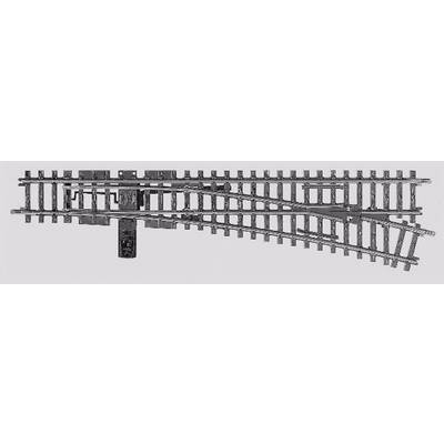 Aiguillage métallique avec de nombreuses traverses transversales et une partie de rail mobile permettant de changer la direction de marche des trains miniatures.