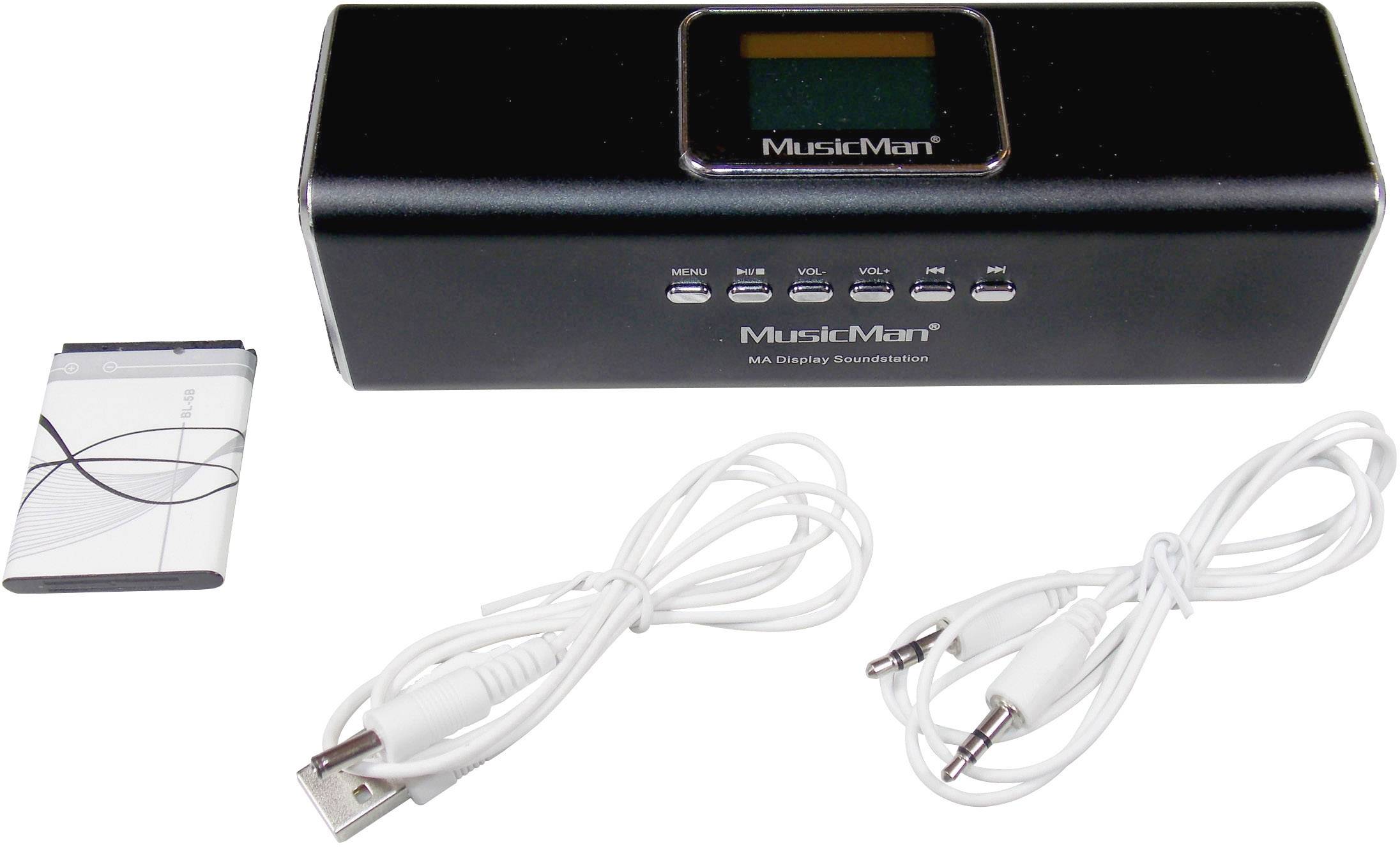 Enceinte portable noire 'MusicMan' avec touches de commande, chargeur, 2 câbles et une batterie. Adaptée pour profiter de la musique en déplacement.