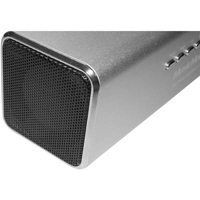 Enceinte Bluetooth métallique en argent, montrant la grille avant et les touches latérales, avec une grille gris foncé à texture circulaire.